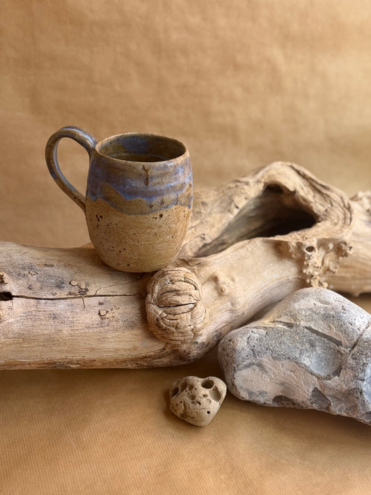 A coastal beach themed mug front view